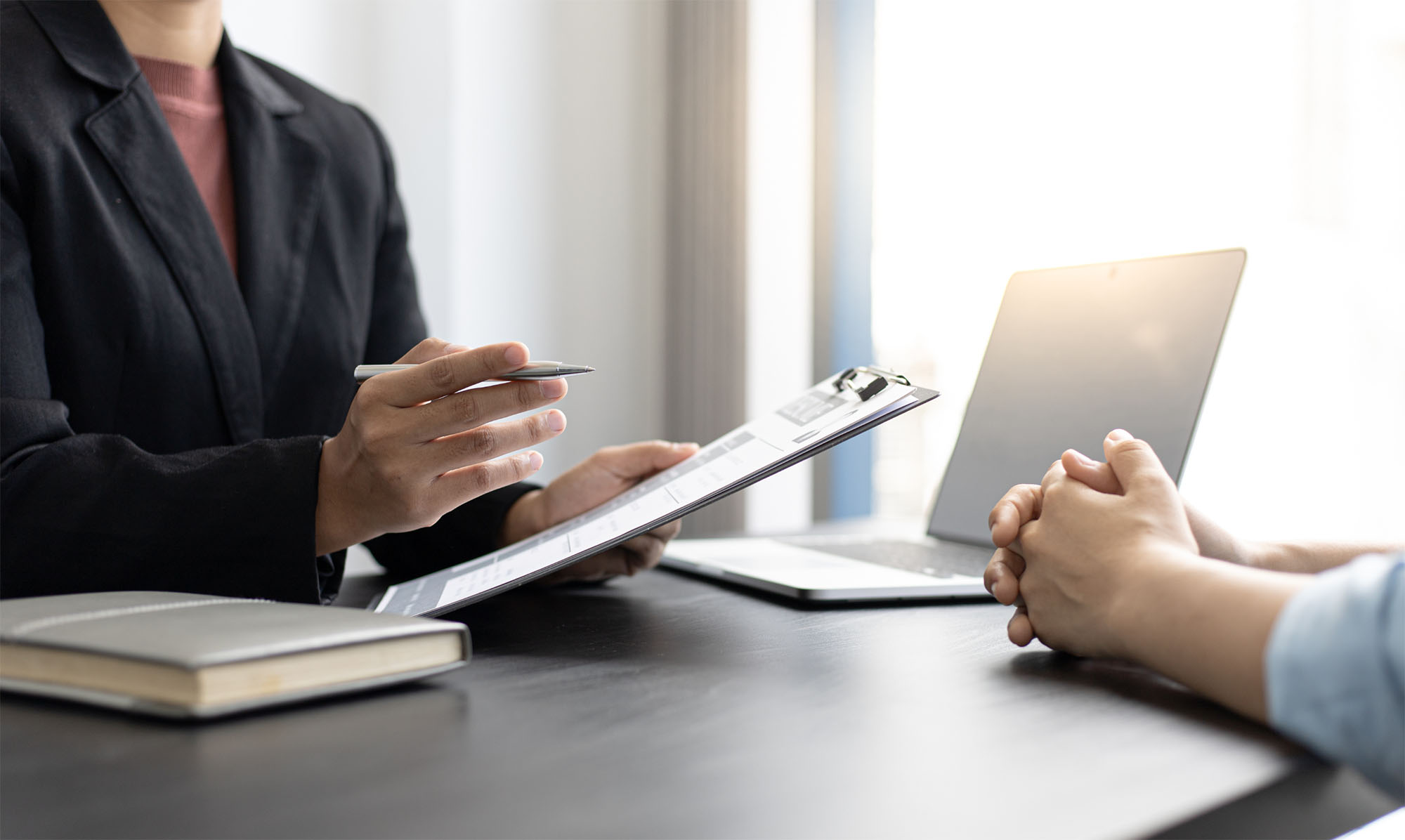 Two people sat at a desk during an interview.