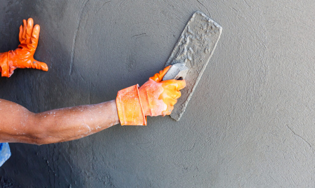 Person plastering a wall