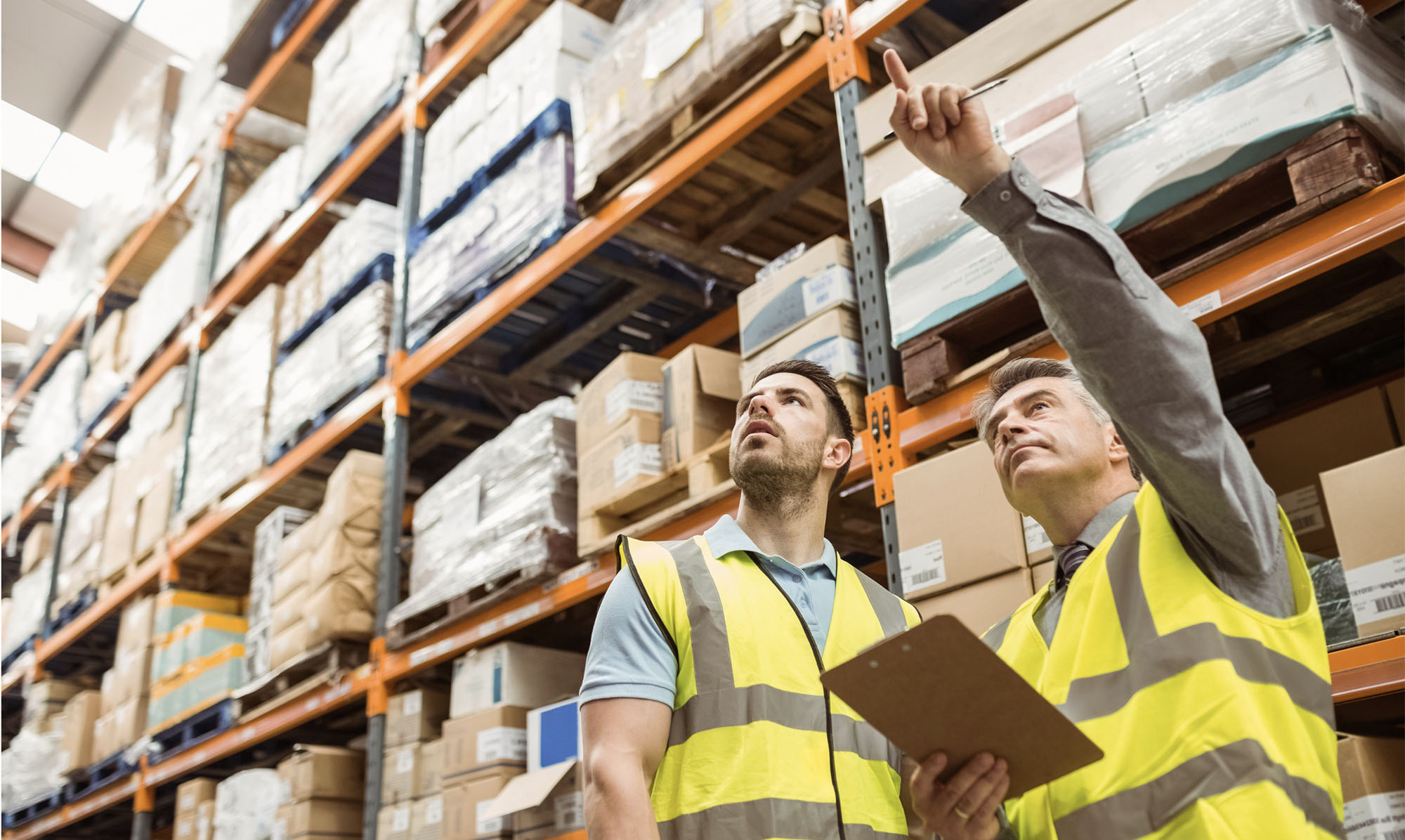 Two warehouse workers locating an item.